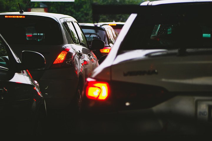 Line of cars stuck in heavy traffic with brake lights glowing, highlighting road congestion and accident risks