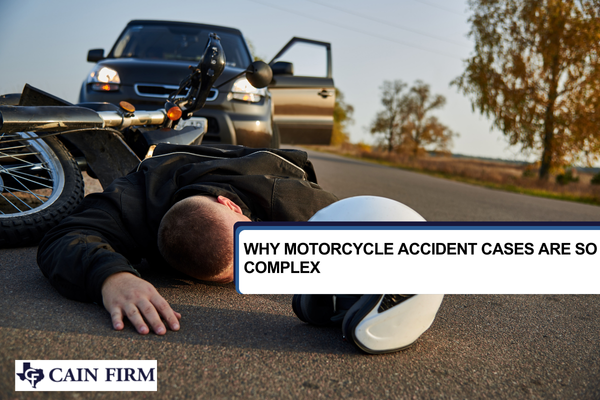 Motorcyclist lying on the asphalt after an accident.